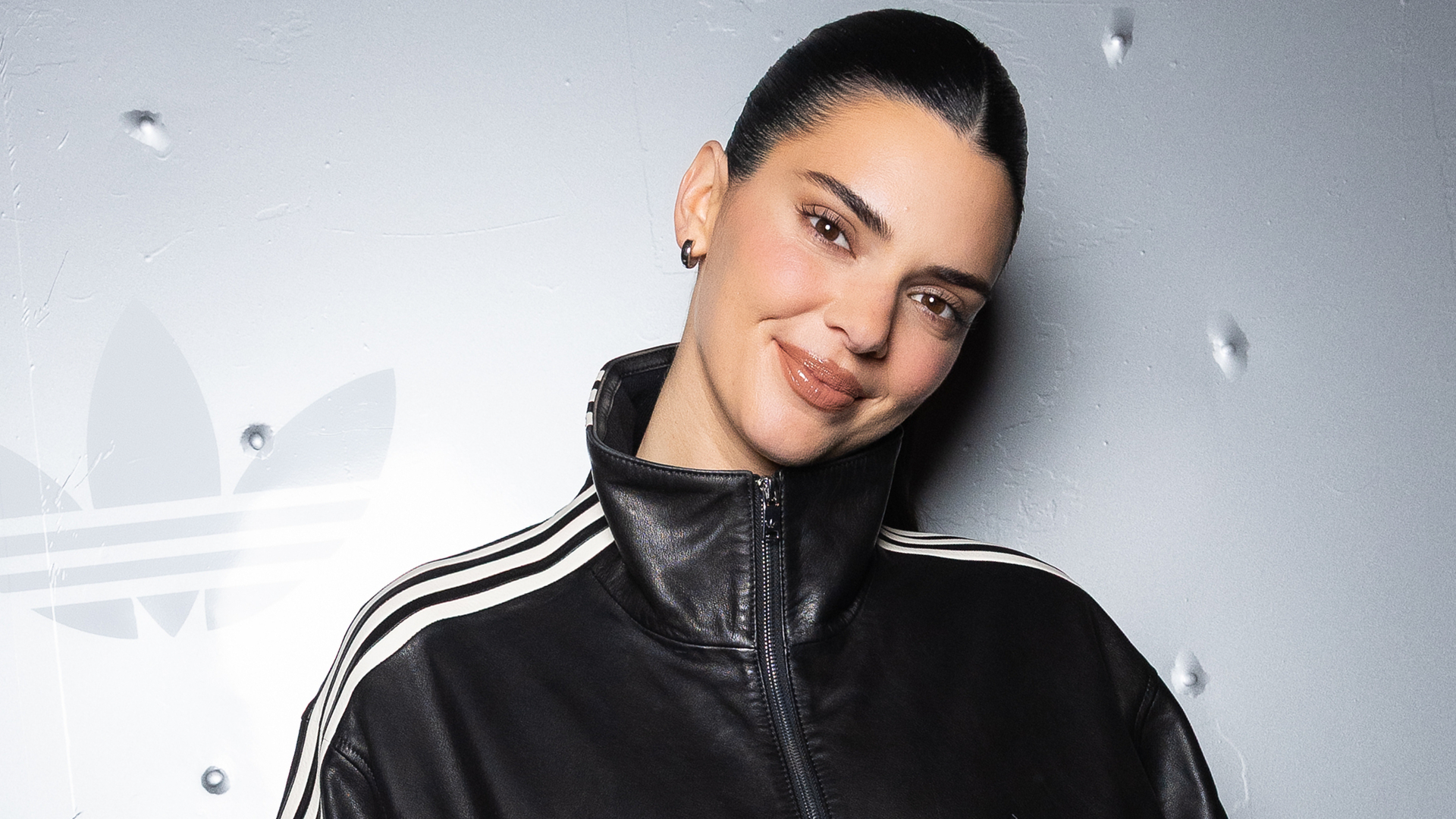 Kendall Jenner attended an Adidas event in a leather take on the track jacket trend and elongated Bermuda shorts