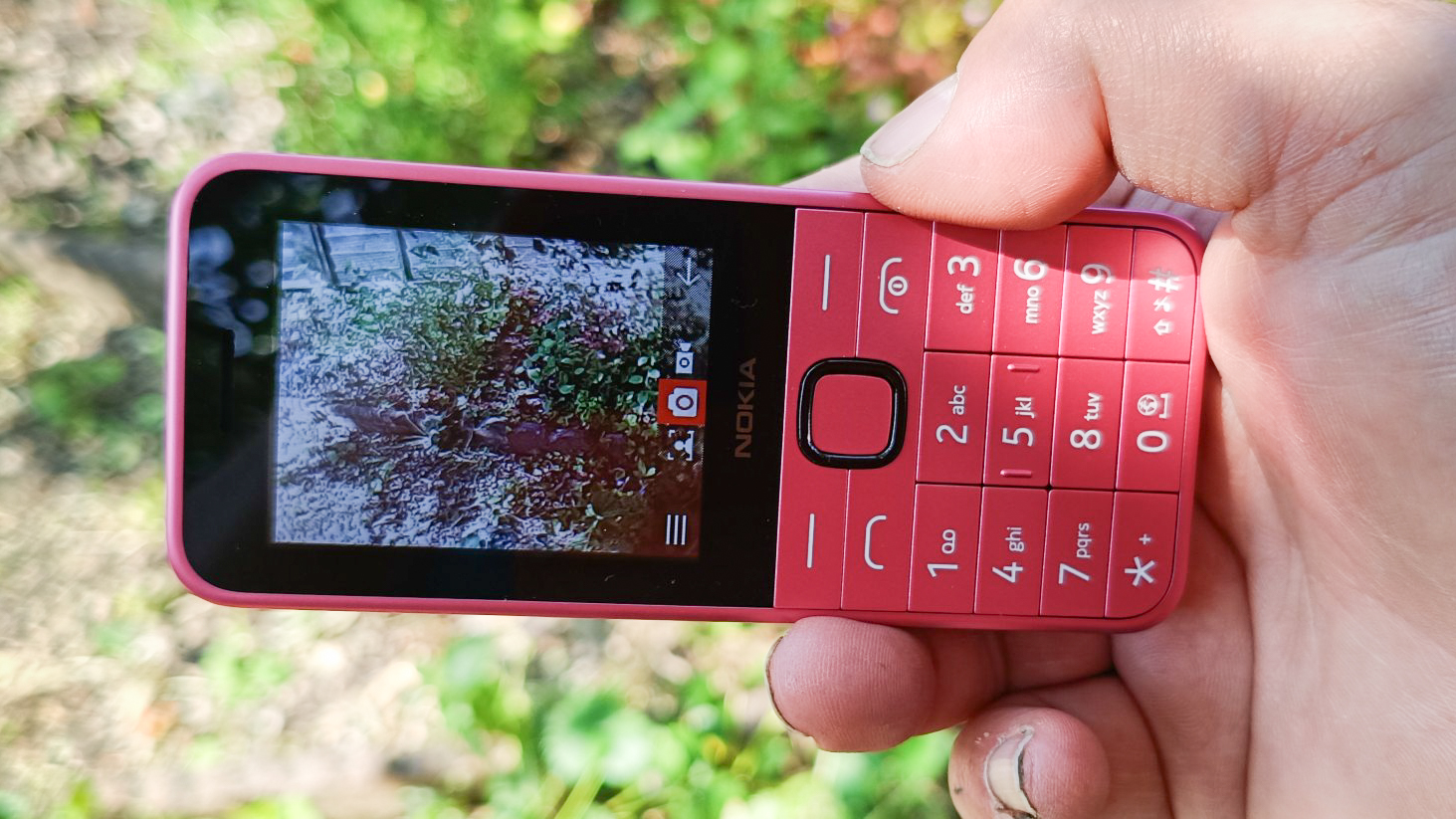 Pink Nokia 225 4G (2024) being held in someone's hand outdoors