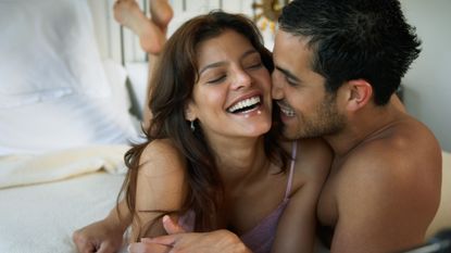 couple laughing in bed