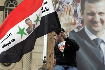 Syrian boy holding flag. 