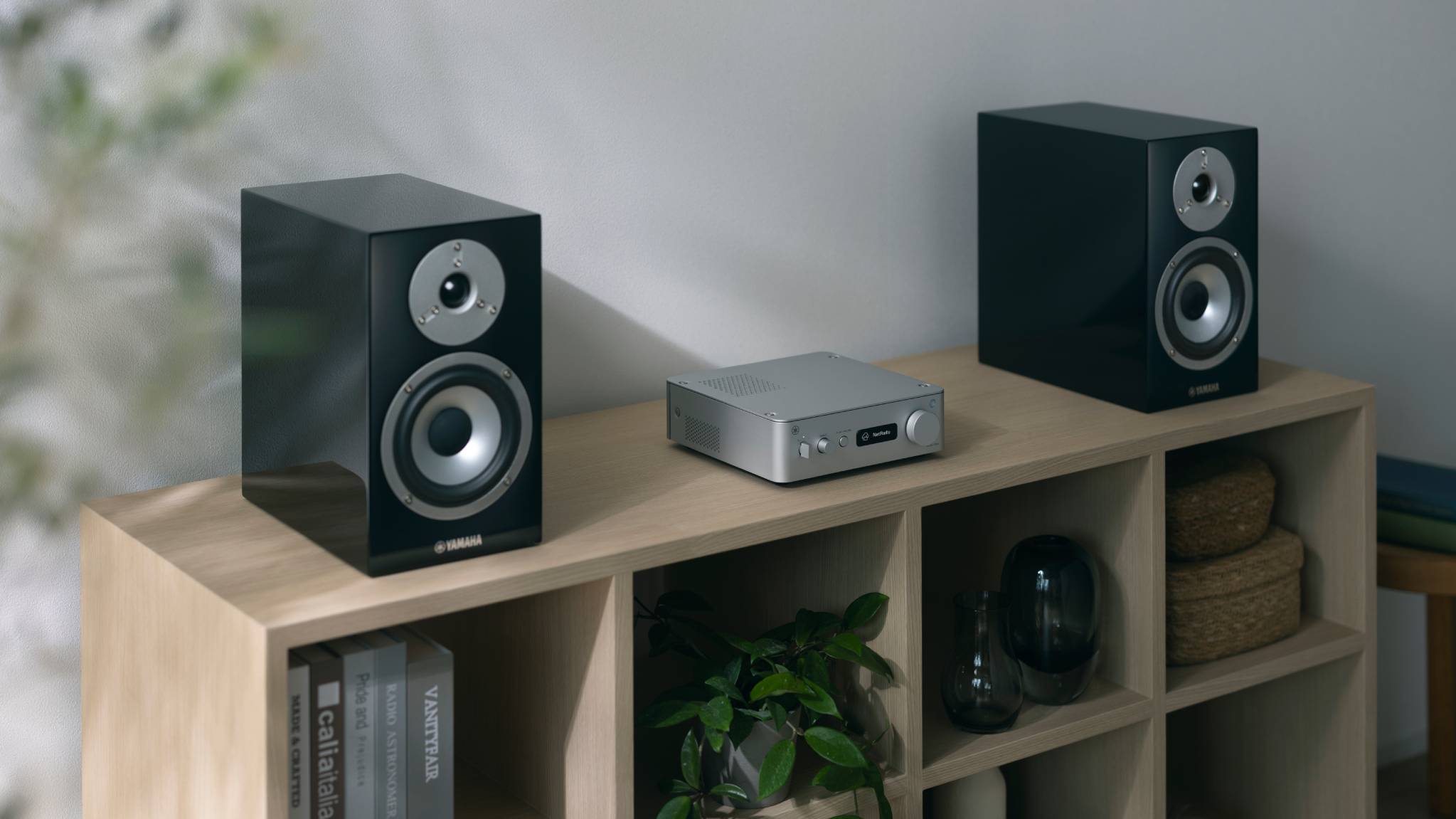 The Yamaha WXA-70A streaming amplifier between two speakers.
