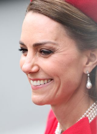 Kate Middleton wearing pearl drop earrings and a pearl choker smiling during the 2025 Commonwealth Day ceremony