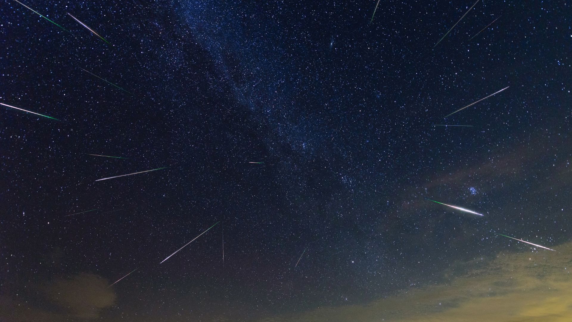 Meteoros são retratados voando em direção à Terra através de um céu noturno estrelado.