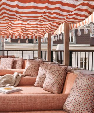 outdoor lounge seating with striped canopy