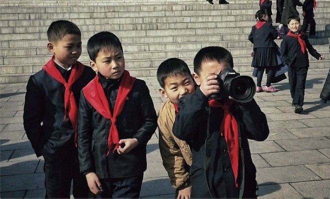 School kids play with one of photographer David Guttenfelder&amp;#039;s cameras at Mansu Hill in Pyongyang, North Korea.