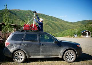 Geologist Ron Karpilo adjusts a GoPro camera mounted on his Subaru. Karpilo photographed every inch of Denali's only road in the summer of 2013 to provide a baseline for environmental monitoring of the park.