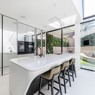 kitchen with white counter chairs and glass doors