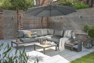 Large corner sofa with a cantilevered parasol on a patio space