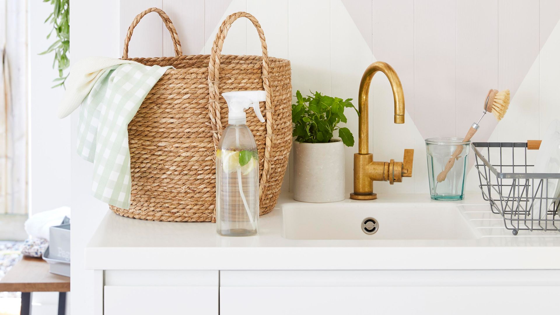 kitchen countertops with storage basket and cleaning products ready to reorganize under the kitchen sink