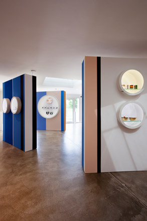 White stand with art sculptures in circle shelves