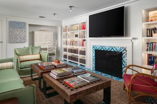 Basement living room with white walls and fireplace