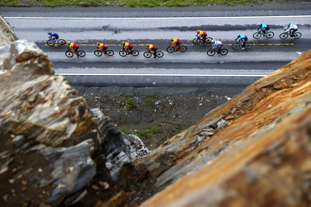 BRONNOYSUND NORWAY AUGUST 12 Tobias Halland Johannessen of Norway Idar Andersen of Norway Frederik Dversnes of Norway Anders Halland Johannessen of Norway Erik Nordsaeter Resell of Norway Martin Bugge Urianstad of Norway and UNO X Pro Cycling Team Gleb Syritsa of Russia and Team Astana Qazaqstan White Best Young Rider Jersey and a general view of the peloton passing through the Svenningdal vre 119m area during the 9th Arctic Race Of Norway 2022 Stage 2 a 1543km stage from Mosjen to Brnnysund ArcticRace on August 12 2022 in Bronnoysund Norway Photo by Michael SteeleGetty Images