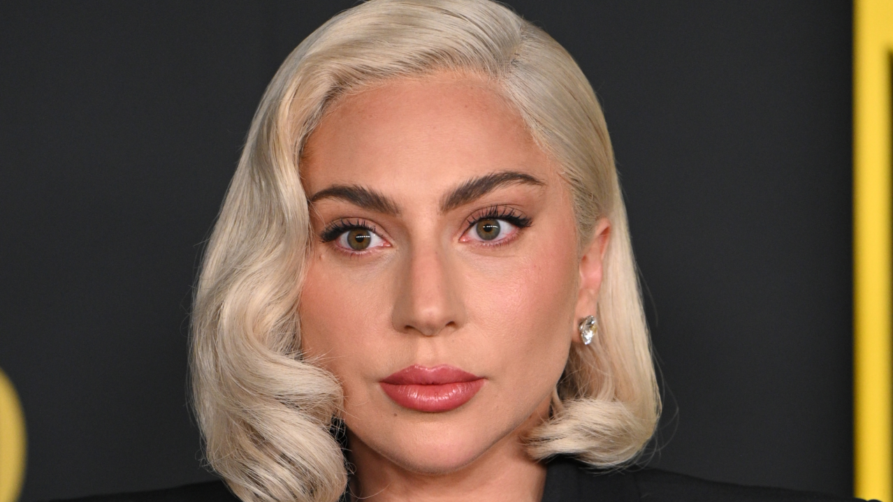 Lady gaga on a red carpet with a blonde bob and full makeup