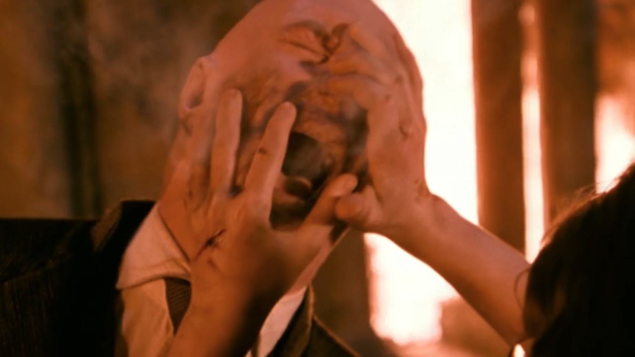 Harry Potter's hands on Quirrell's face while he screams.