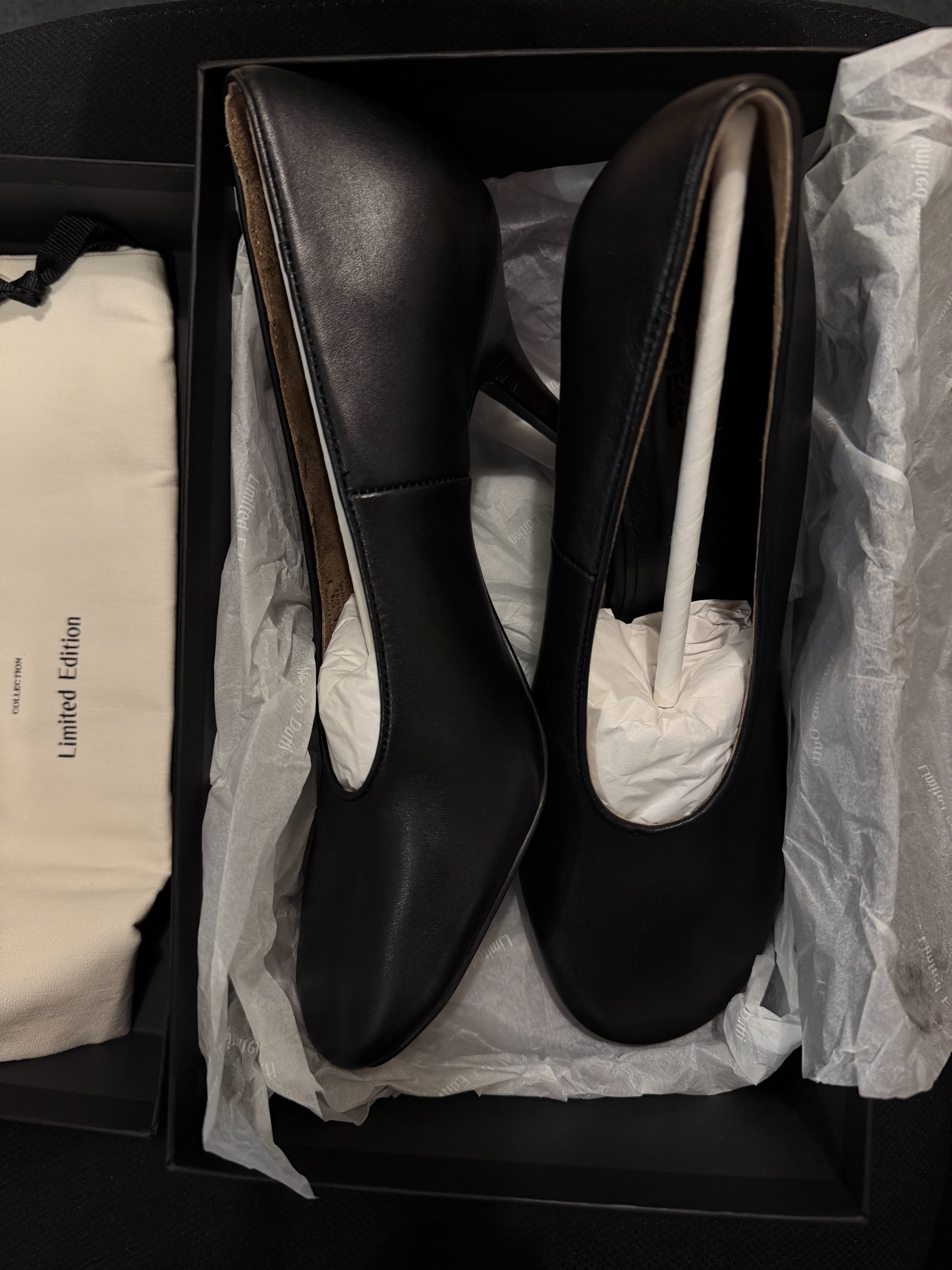 A pair of black round-toe pumps from Massimo Dutti.
