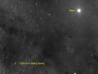 The Comet Siding Spring (C/2013 A1) is seen near Mars on Oct. 19, 2014 by a telescope with the Slooh Community Observatory during a rare flyby that scientists called a once-in-a-lifetime event. The comet flew within 87,000 miles of the surface of Mars dur