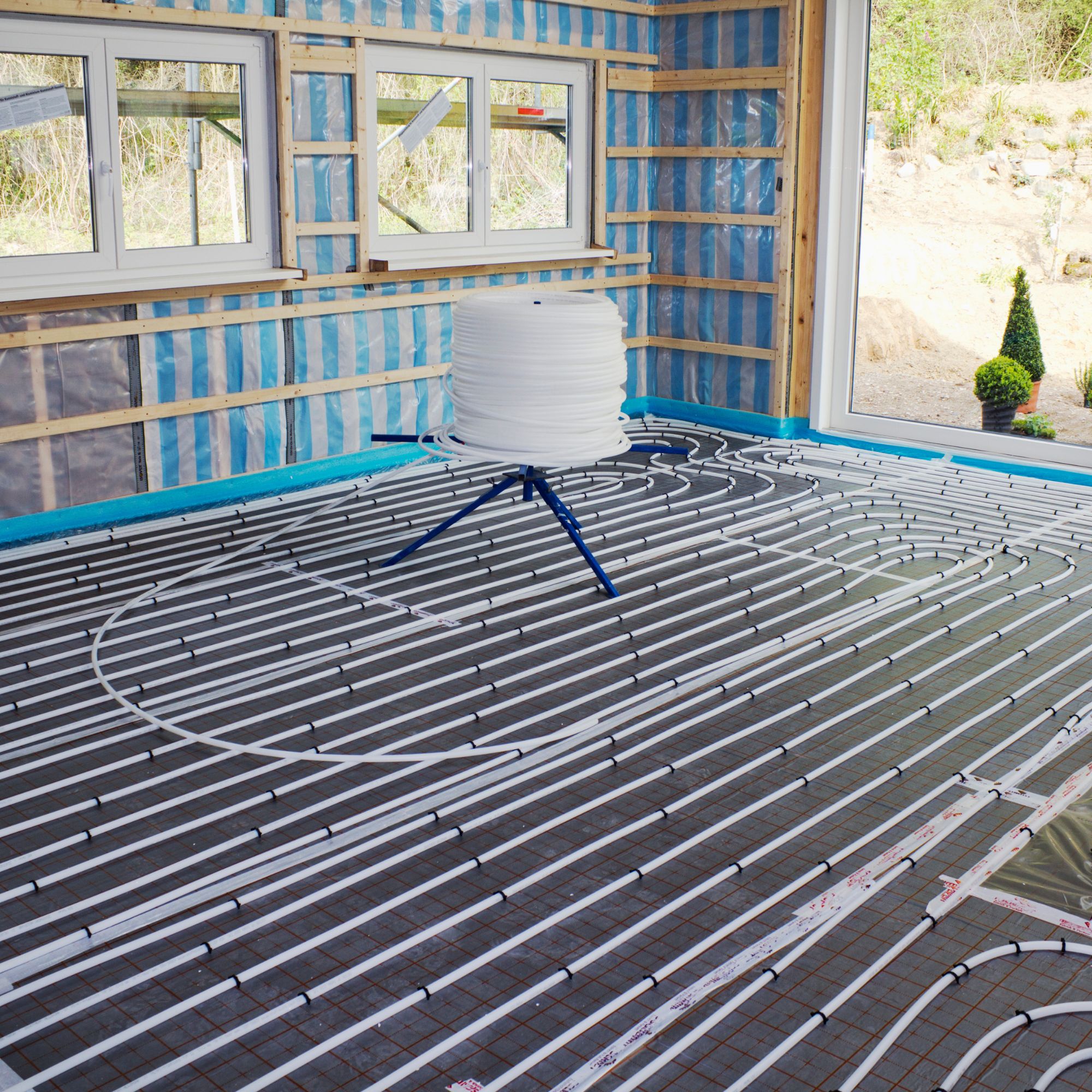 Underfloor heating pipework being laid in new build extension