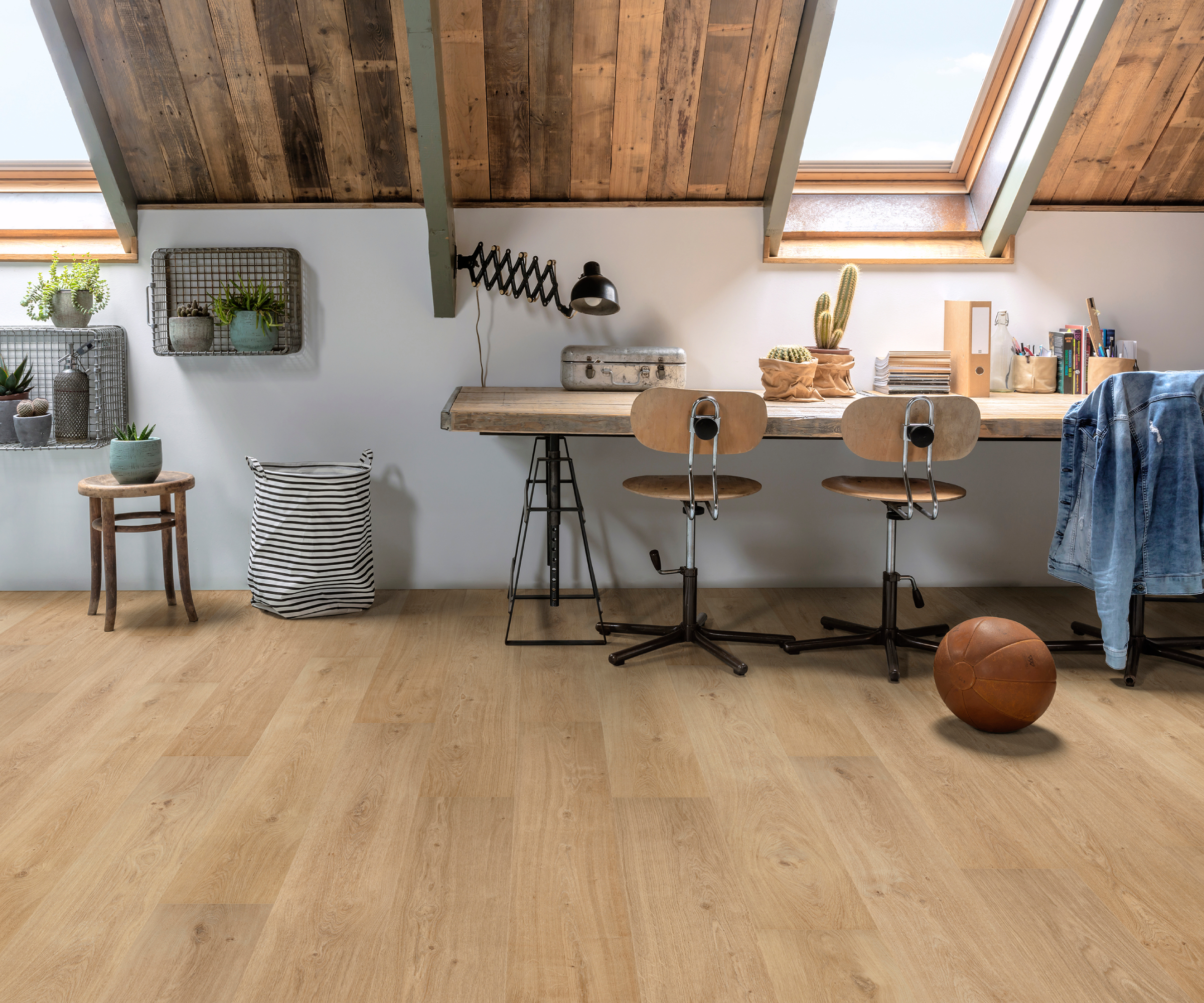 velux loft conversion with desk below window, wooden effect flooring and clad ceiling with timber