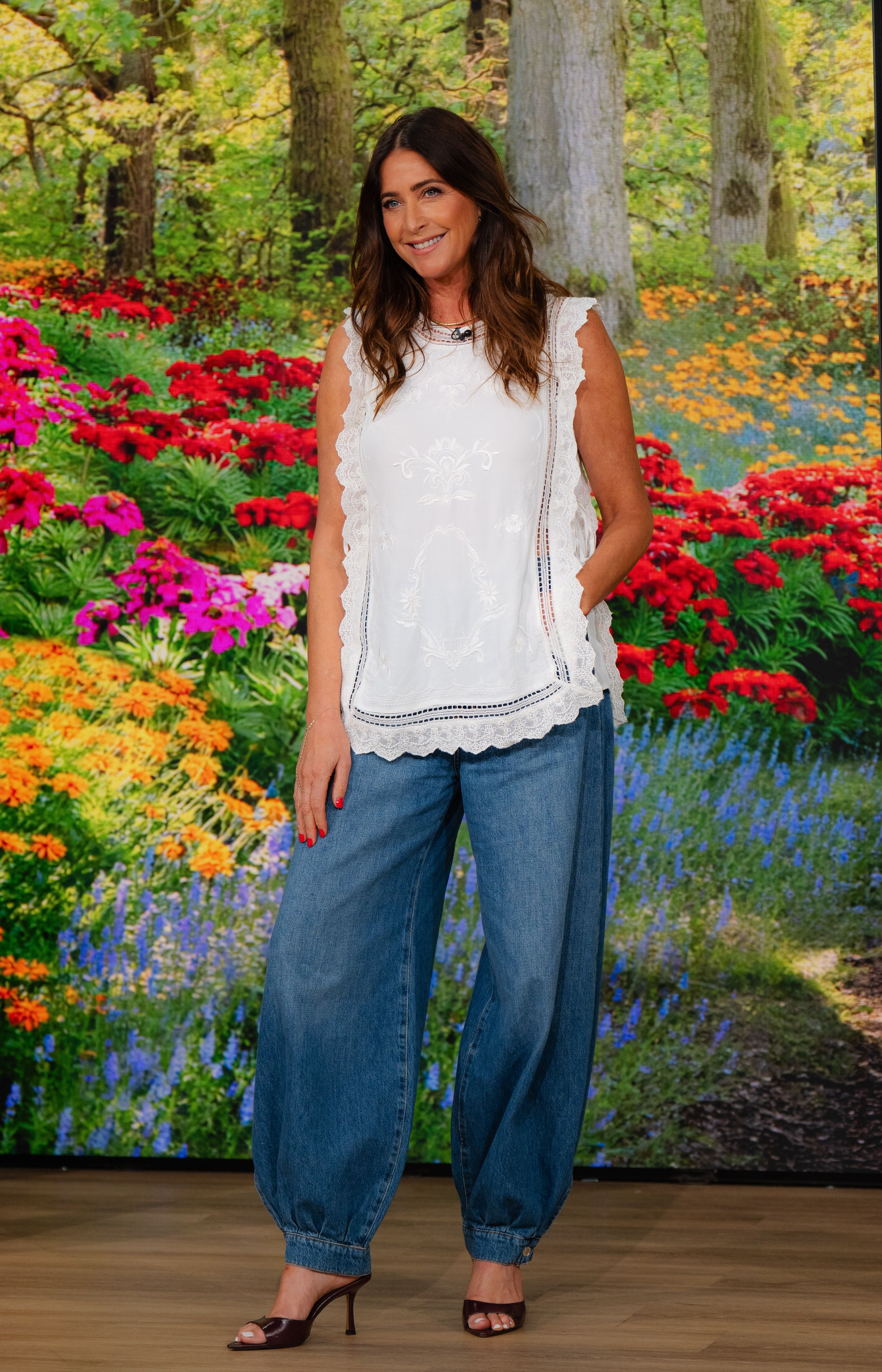 Lisa Snowdon in cuffed jeans and a bib top