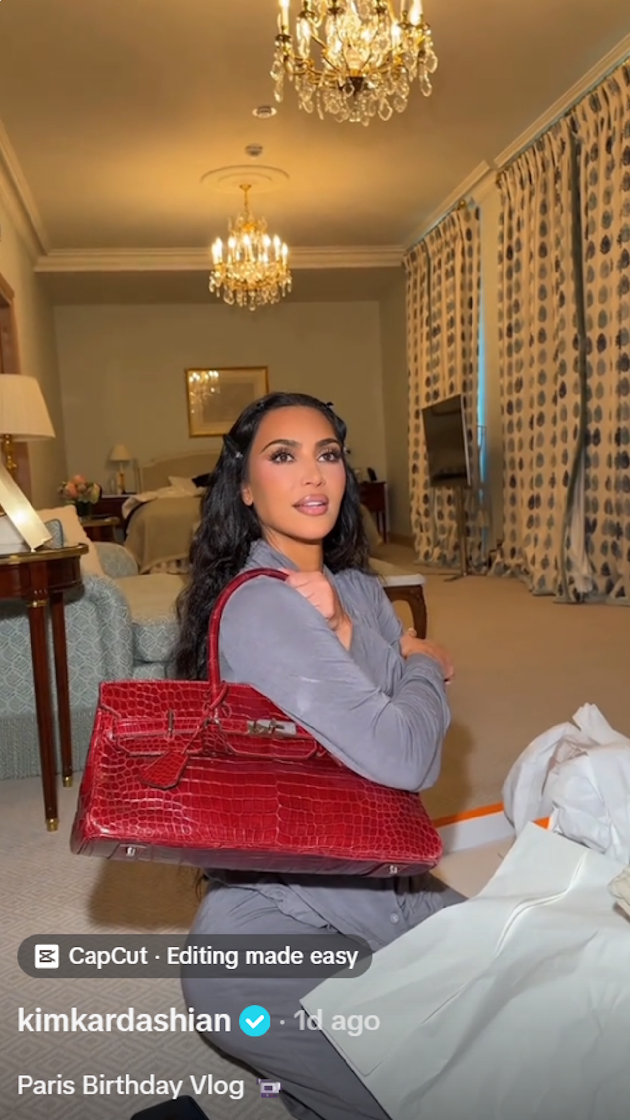 Kim Kardashian holds a red Birkin bag gifted to her by mom Kris Jenner for her 45th birthday in a birthday vlog posted to TikTok.