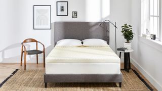 Molecule Copperwell Mattress Topper with cooling gel pictured on a white mattress placed on a grey bedframe in a white bedroom