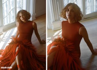 Halle Berry in a red feather dress leaning on the ground