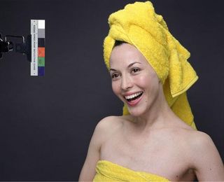 Photograph of a woman smiling in yellow towels.