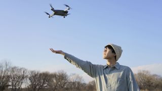 Drone deals: Image shows young man flying drone
