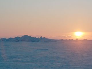 Sun sets over Greenland's sea ice.