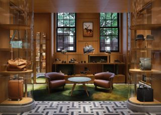 A wood-panelled sitting room with leather chairs inside Hermès store Madison Avenue