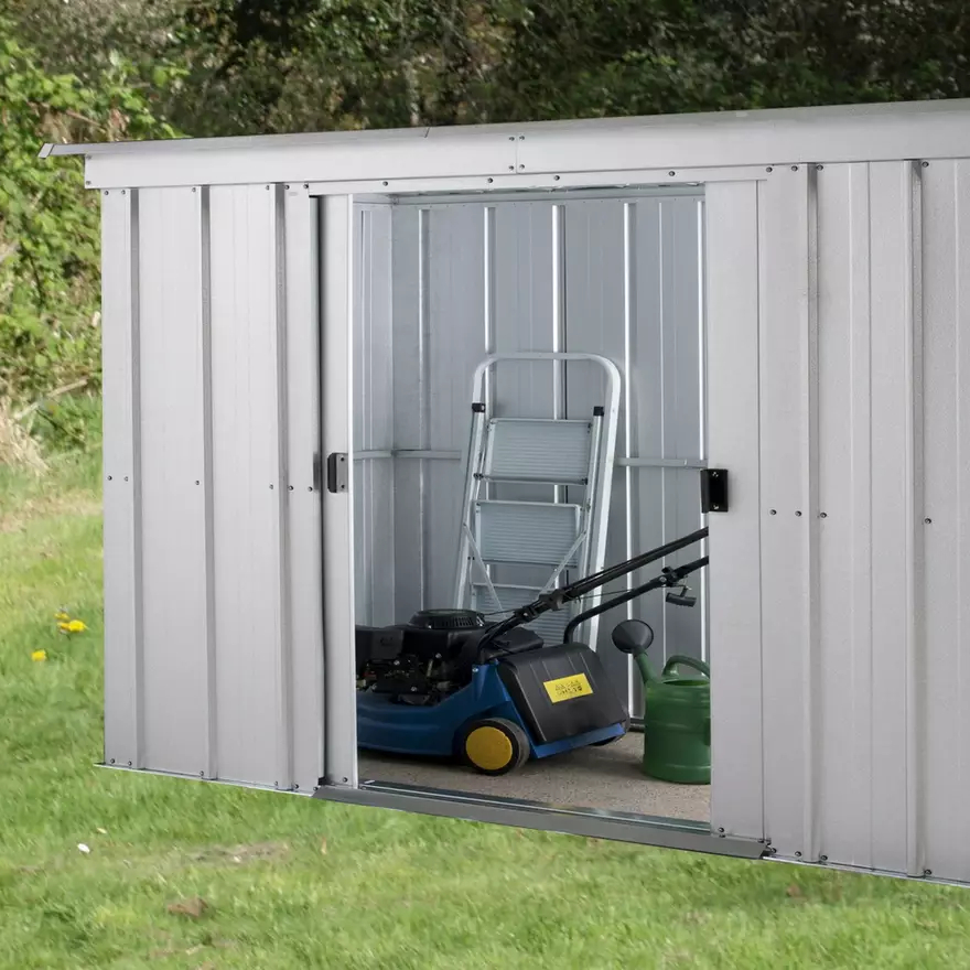 grey metal shed with door open and mower inside