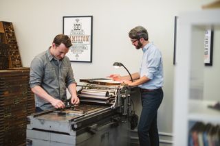Designer Matt Braun (left) and founder Matt Griffin at their Vandercook no 4 printing press