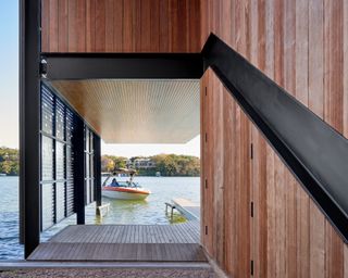 at the building's entrance lookingthwards the boats and water at the Filtered Frame Dock boathouse by Matt Fajkus Architecture