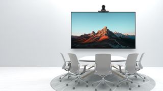 MAXHUB introduces next-generation UC P25 PTZ camera bringing unprecedented clarity to video conferencing, shown here in a boardroom with a white desk and vivid display on a LED screen.