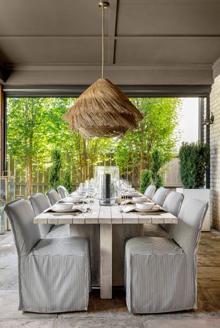 An outdoor dining space with upholstered chairs