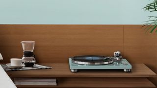 TEAC TN-400BT X-TB Bluetooth turntable in turquoise on a wooden surface