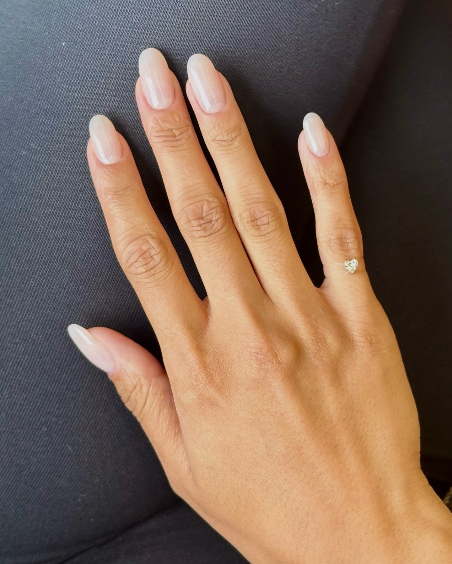 A long, almond-shaped pearlescent manicure
