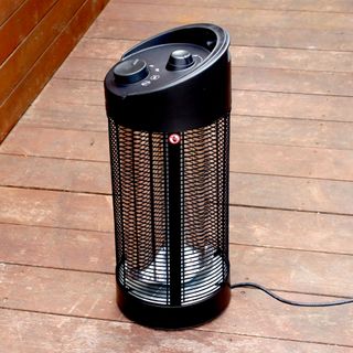 The Blumfeldt Heat Guru 360 patio heater being tested on wooden decking outdoors