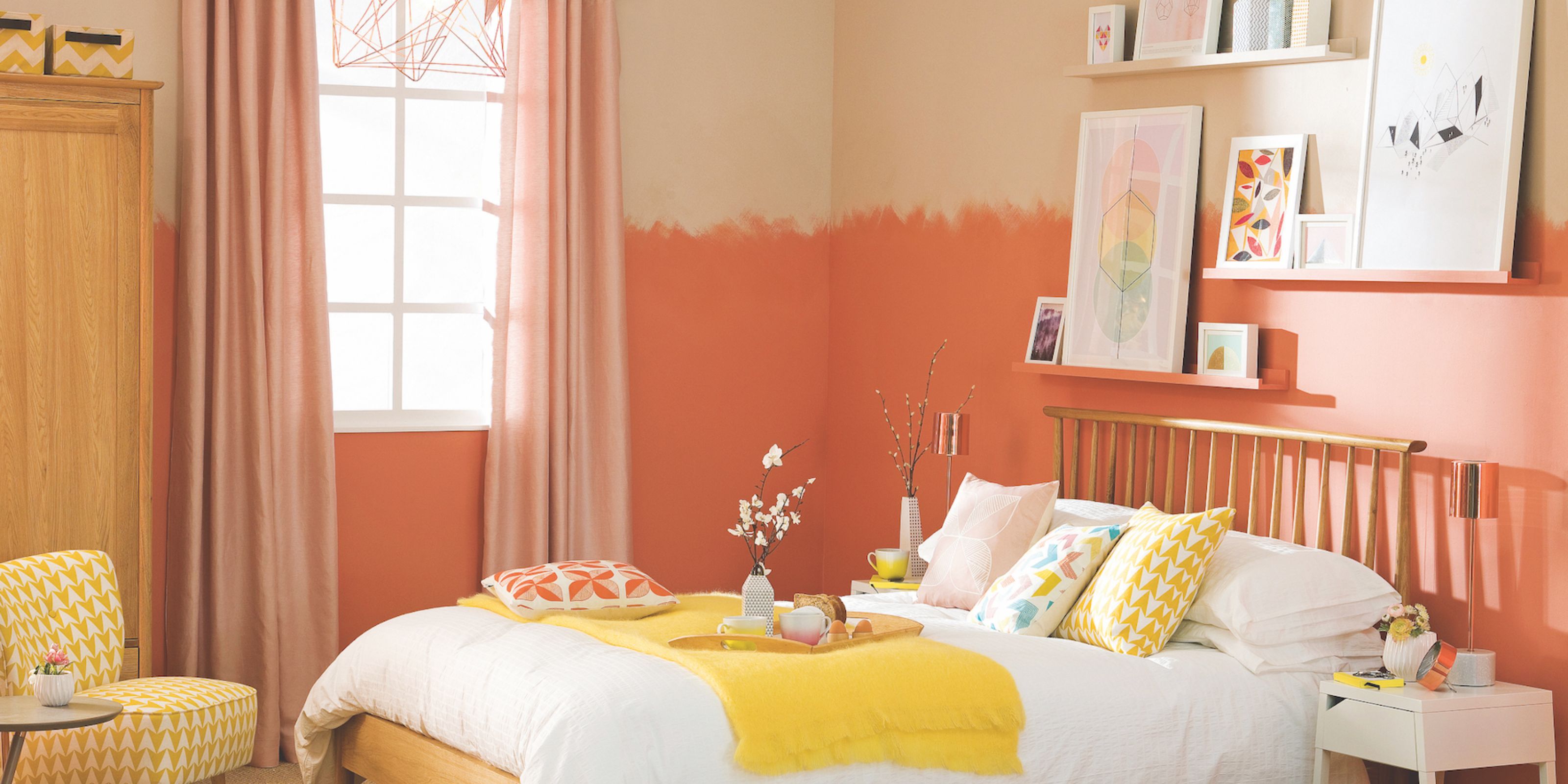 A bedroom with tones of pink and orange in the decor