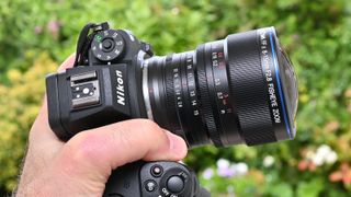 Laowa 8-15mm f/2.8 FF Zoom Fisheye product image of lens held in hand