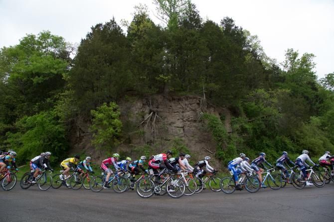 The peloton rounds a bend near Rudy, Arkansas during Friday's road race. Although the forecast called for an 80% chance of rain, the stage was spared all but the lightest rainfall.