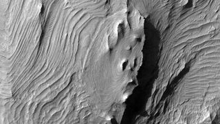 The folded layers of eastern Candor Chasma on Mars.