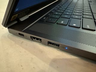 A silver Acer Chromebook Plus on a grey table