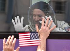 NASA astronaut Serena Aunon-Chancellor gestures from inside a bus before the launch of the Soyuz MS-09 spacecraft at the Russian-leased Baikonur cosmodrome on June 6, 2018.