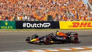 Red Bull Racing's Dutch driver Max Verstappen salutes supporters after he took the pole position during Dutch Grand Prix Formula One race at Circuit Zandvoort.
