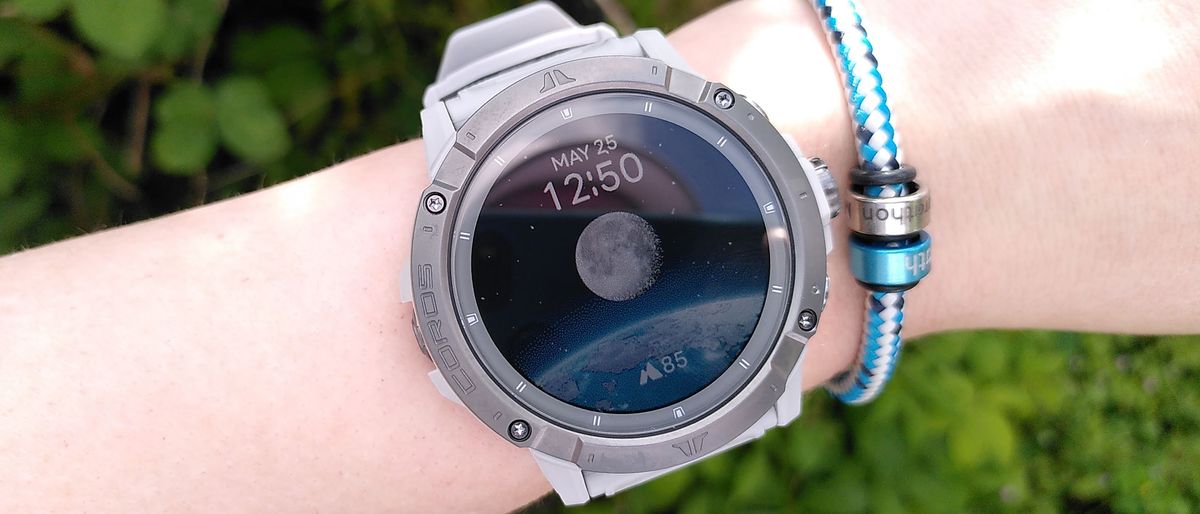 Coros Vertix 2S watch on woman&#039;s wrist showing home screen with moon graphic