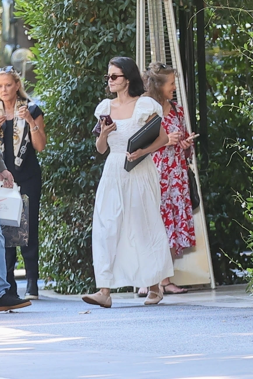 Selena Gomez wearing a white doen dress and mary janes in los angeles
