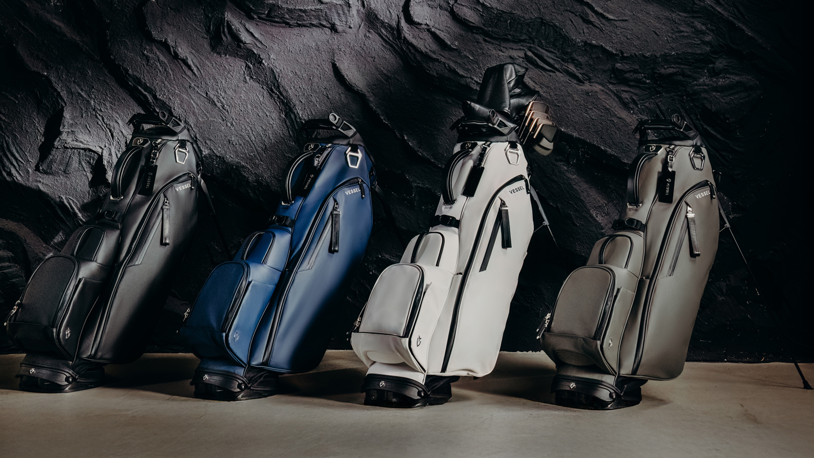 Four Vessel golf bags indoors