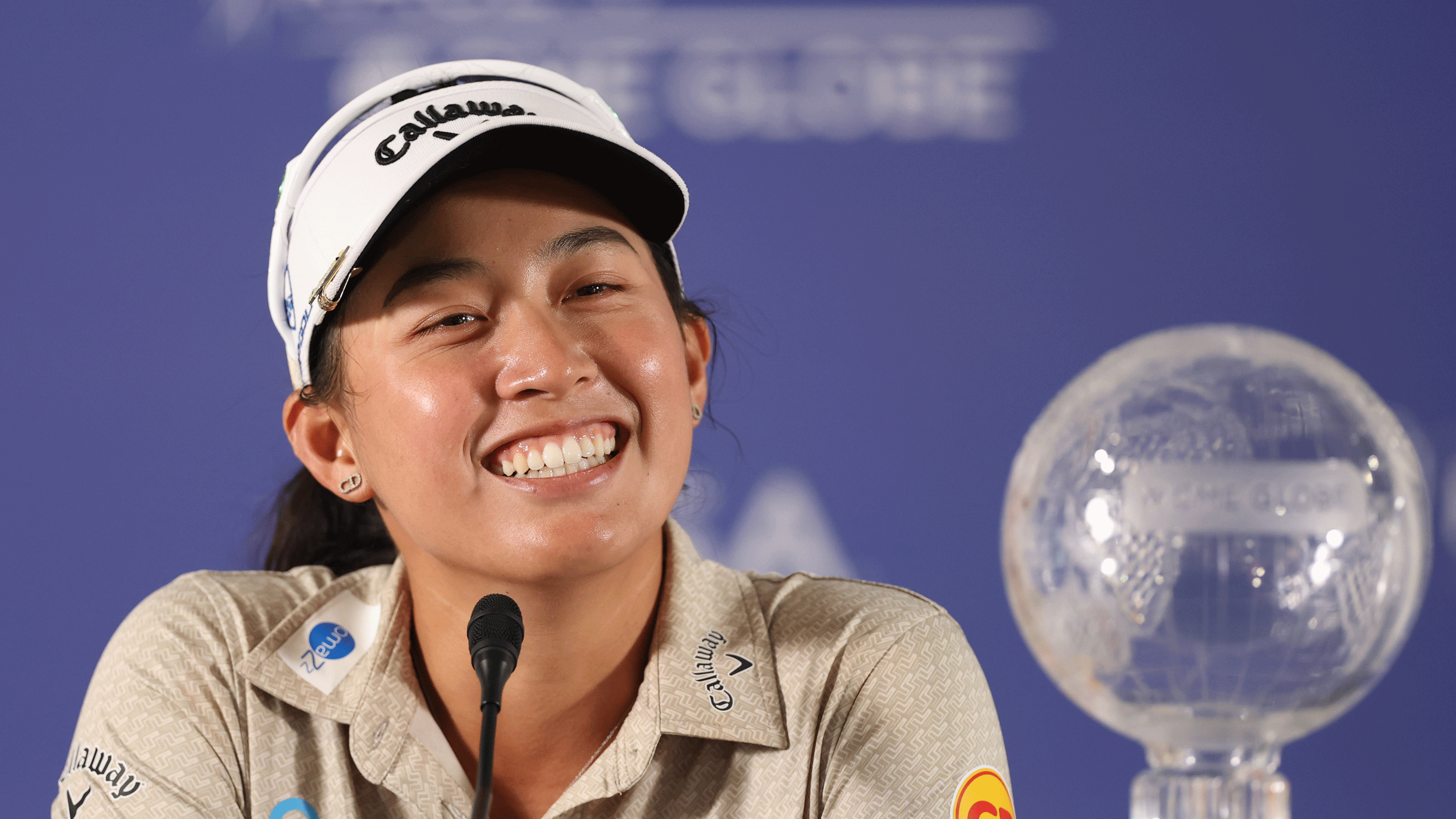 Jeeno Thitikul smiles broadly with the CME Group Tour Championship trophy in the foreground