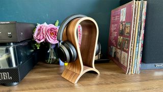 Philips Fidelio L4 noise-cancelling headphones on headphone stand between hi-fi and vinyl records